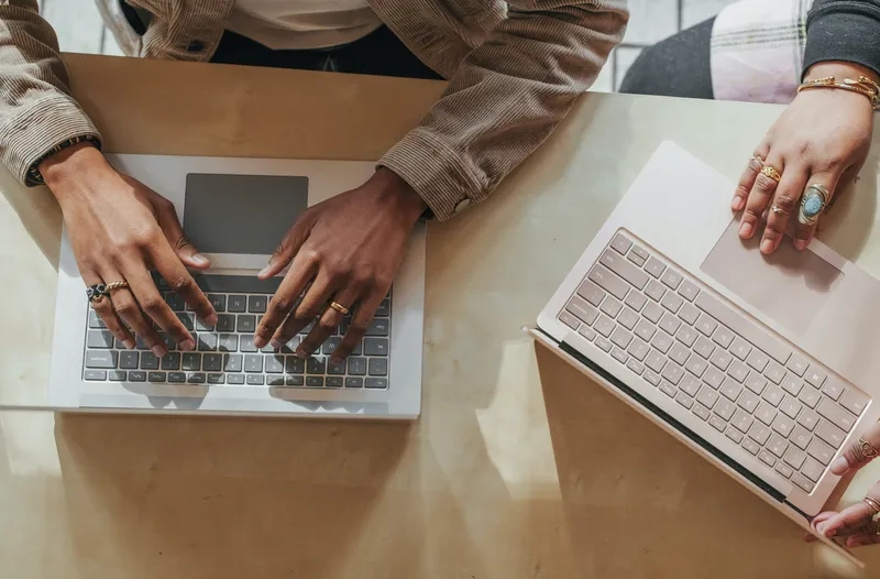 Image of two people working together at a table